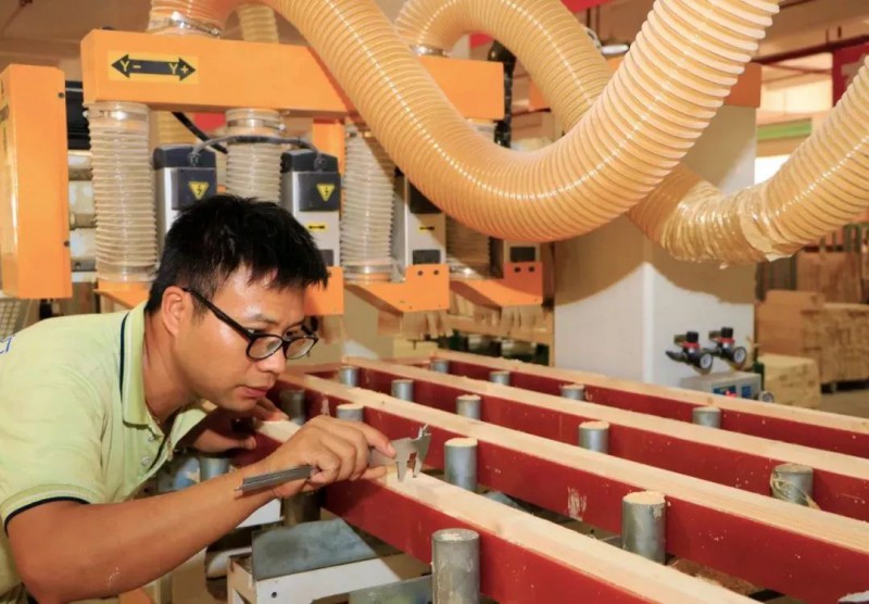 工人在智能化家具生產(chǎn)線上認(rèn)真測量(楊曉明 攝)